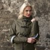 Elegant green rain jacket with reflective cuffs, front view